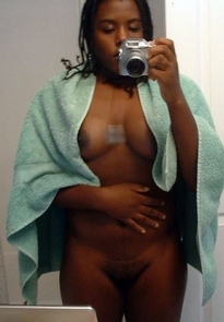 Dark-skinned chick taking a picture